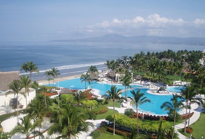 View of a resort style pool near the ocean beside Nuevo Vallarta real estate for sale